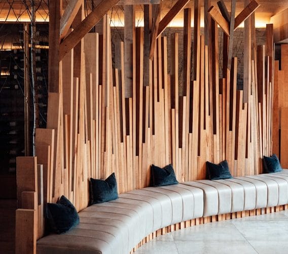 Slatted wood feature wall above built-in bench seating